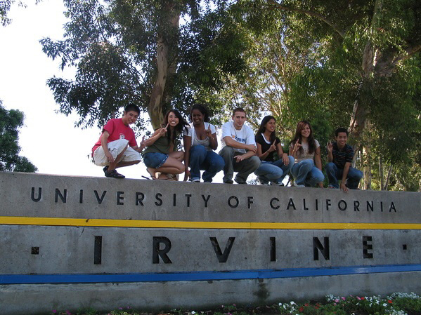 students-standing-on-UC-Irvine-sign